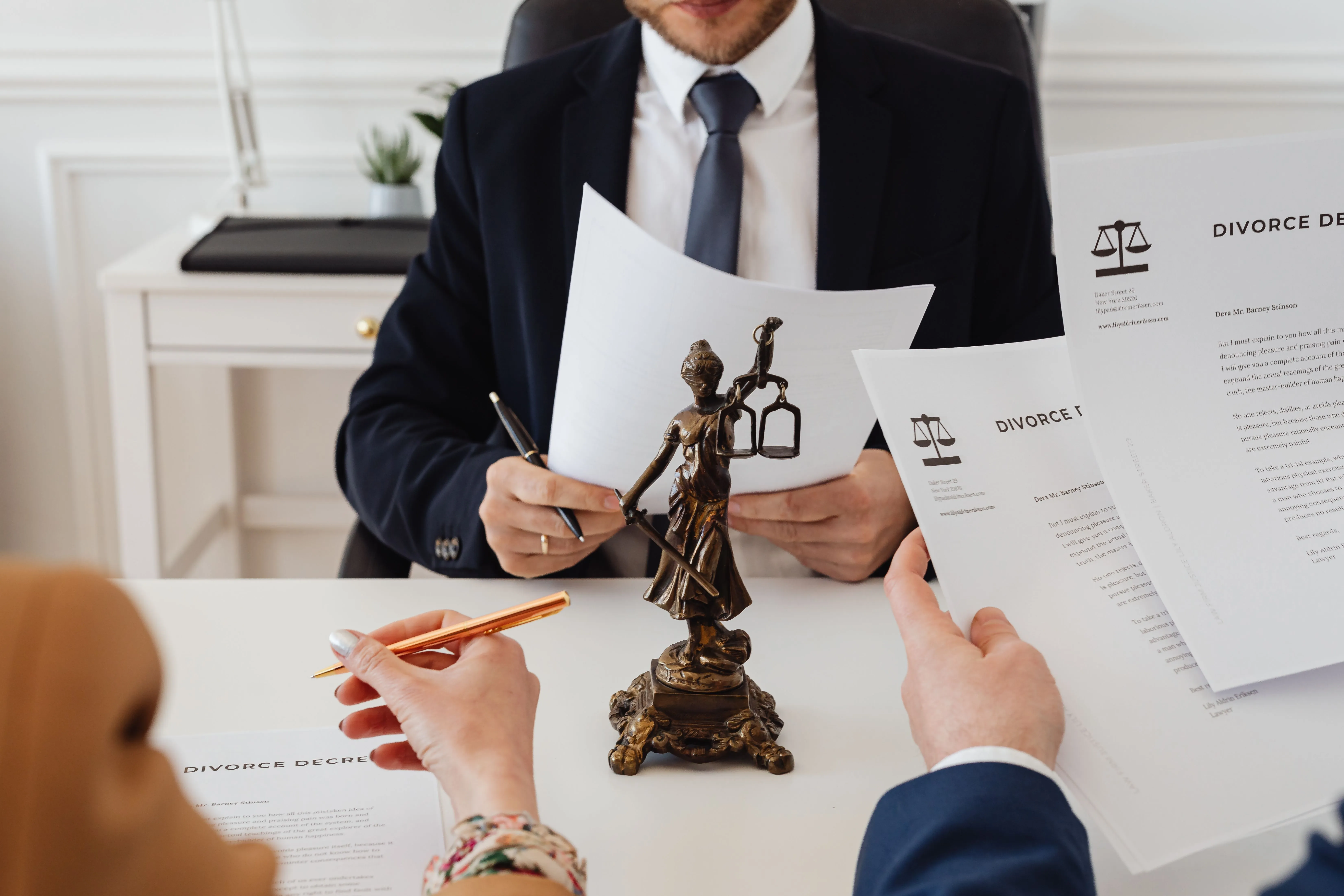 Attorney reviewing legal documents with clients during a record sealing consultation.