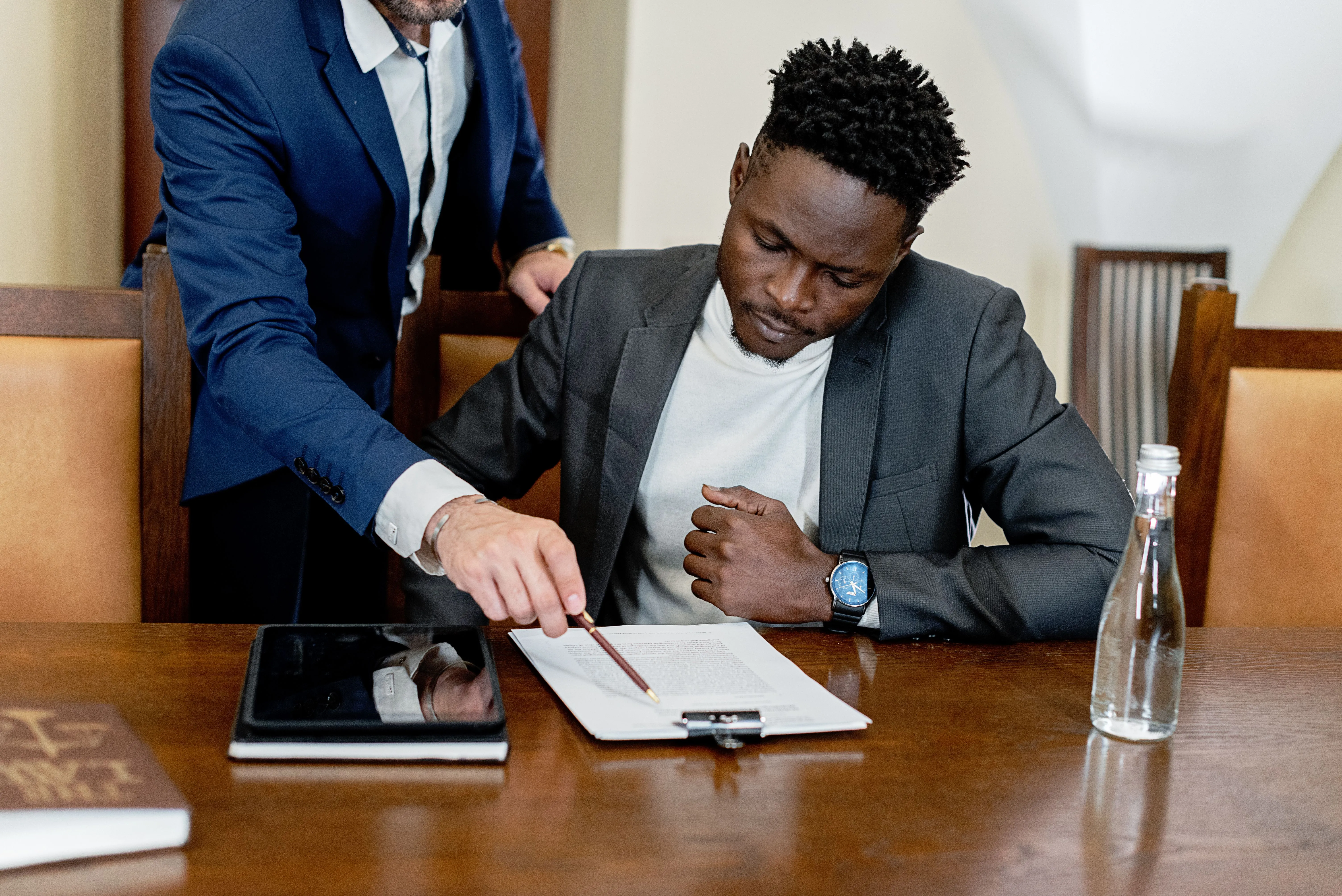 Attorney explaining legal documents to a client during a consultation before signing important paperwork.
